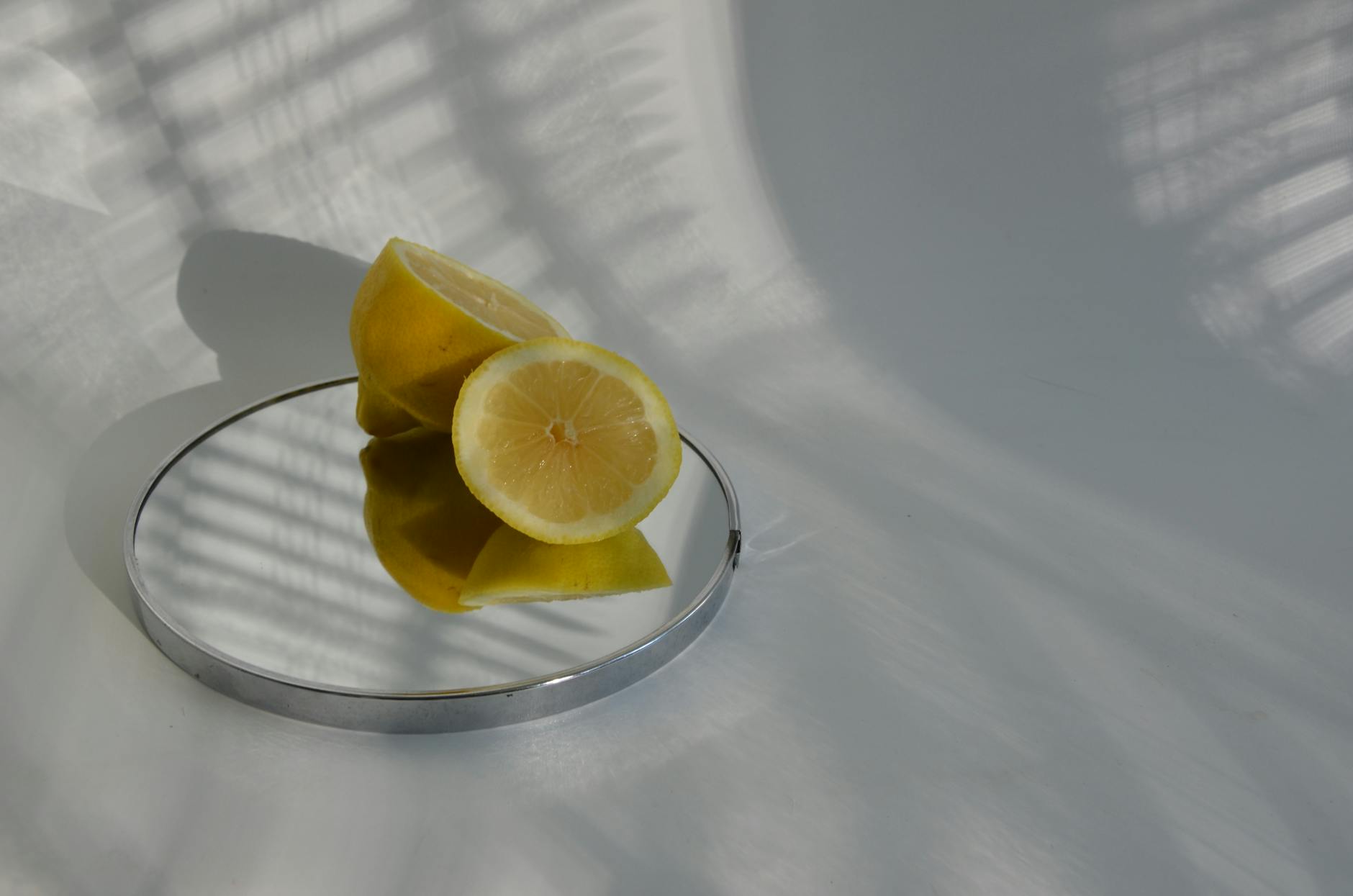 A vibrator surrounded by flowers and citrus on a bright background, symbolizing sensuality and renewal.