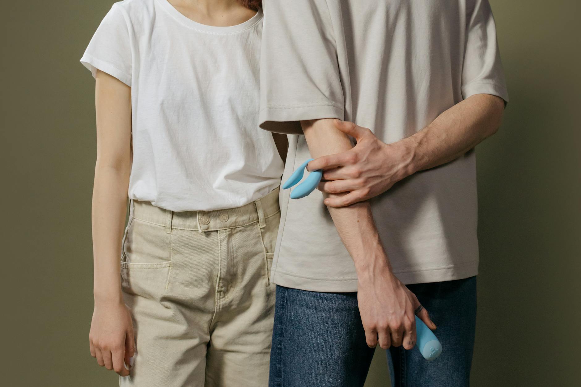 A couple exploring intimate connection with modern clitoral suction technology together.