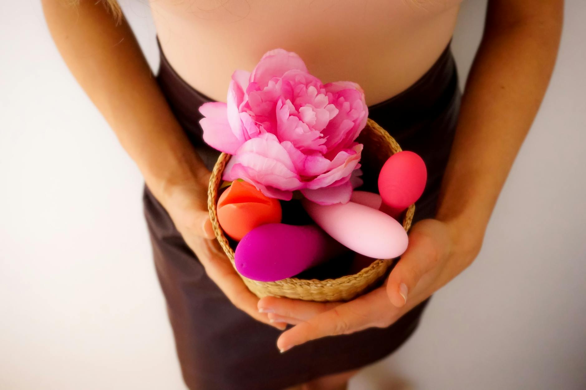 Pink lemon vibrator on purple background with candles