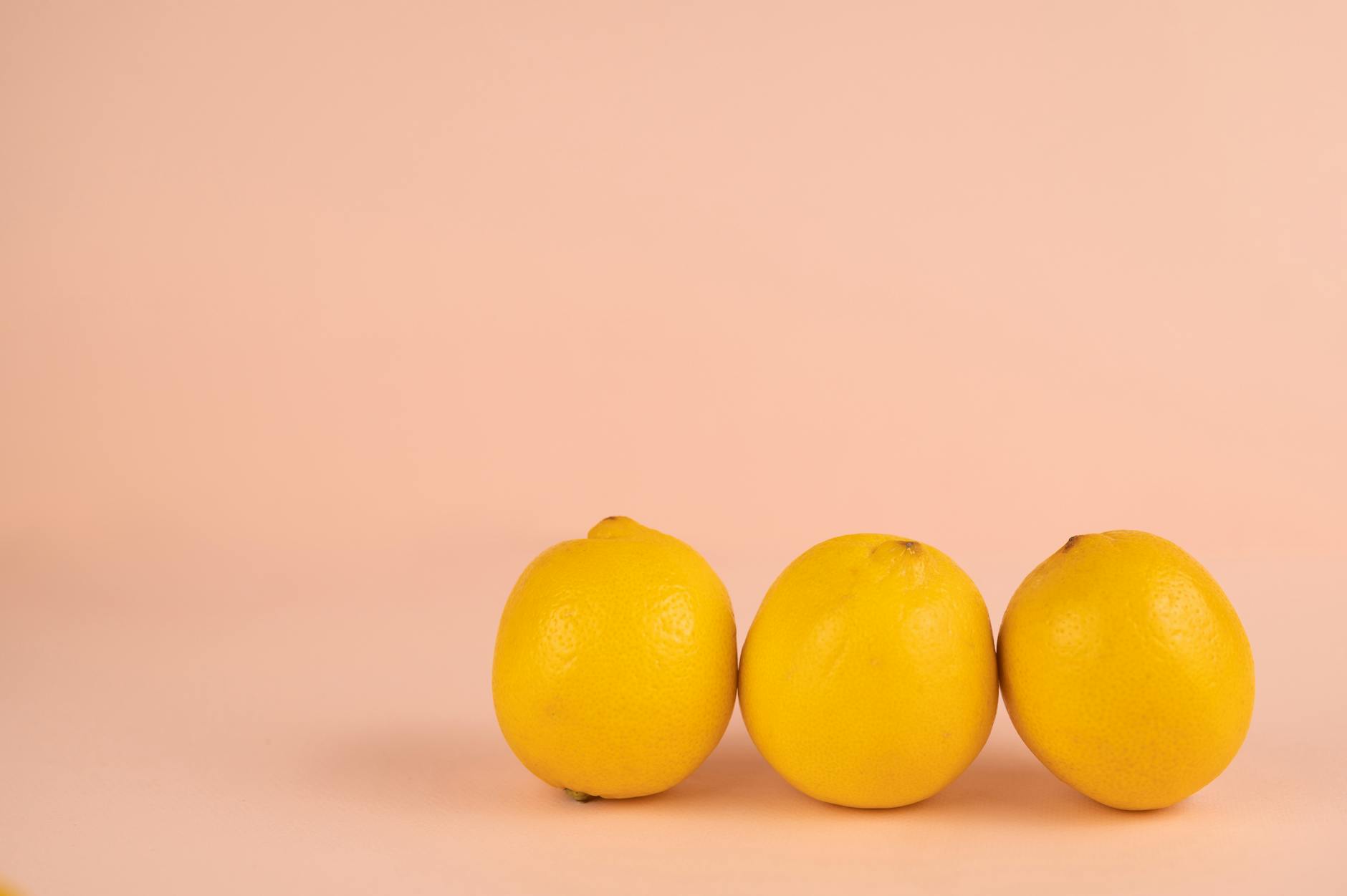 Bright ripe lemons on a pastel background symbolizing fresh approaches to intimate pleasure